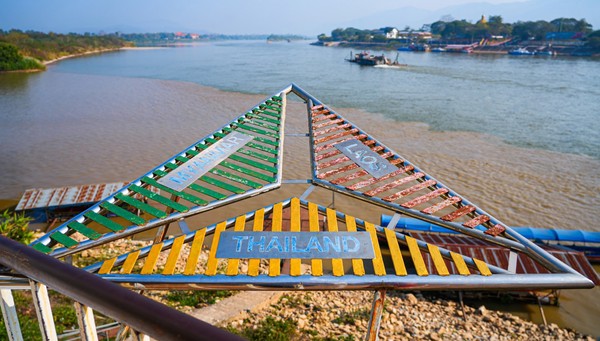 The triangular border marker at the confluence of the Mekong and Ruak rivers in the Golden Triangle Park (Sop Ruak) in Chiang Saen, northern Thailand
